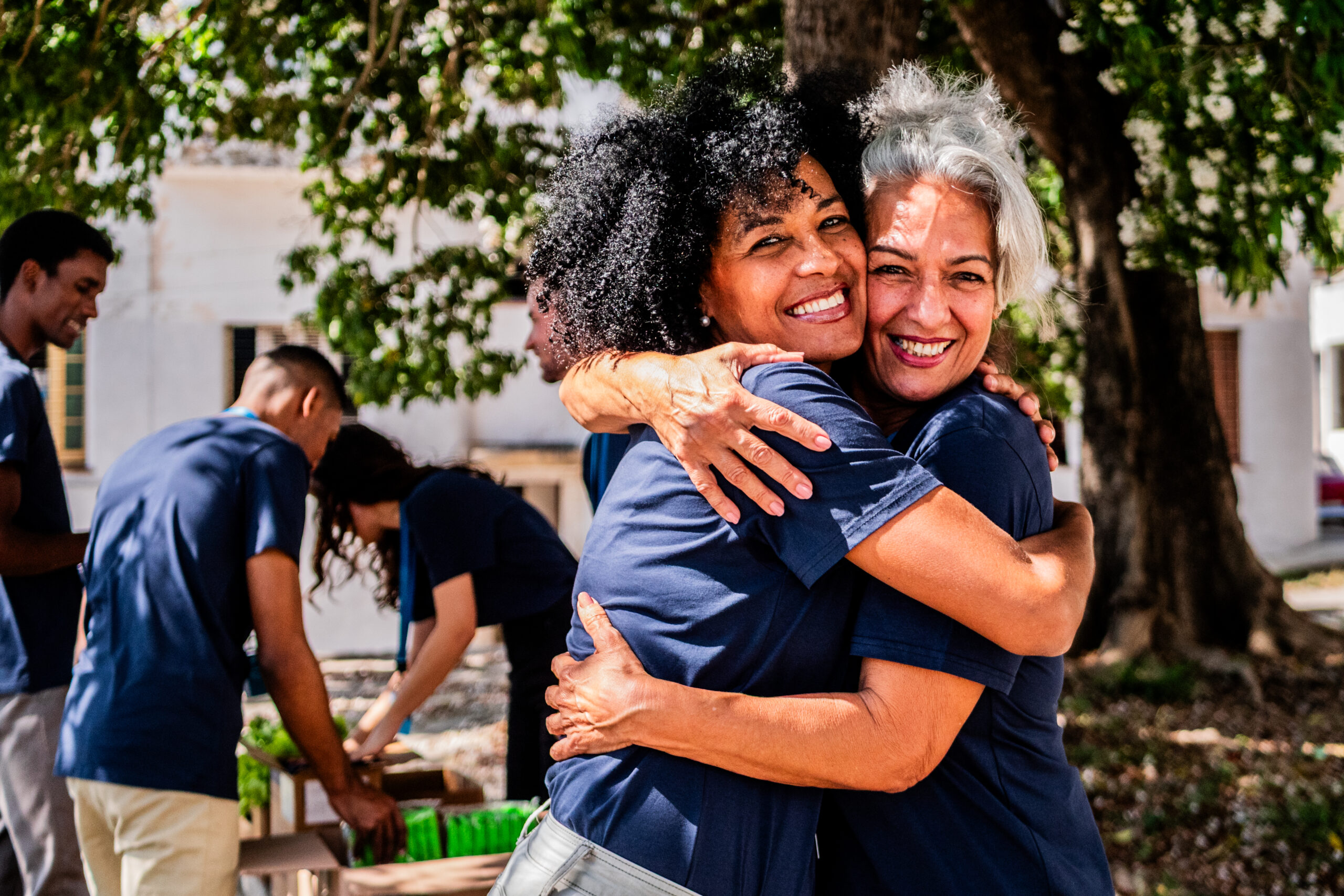 Portrait of volunteer friends embraced outdoors